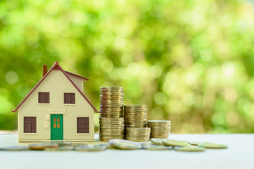 Property investment / reverse mortgage, financial concept : Small home or house model with green...