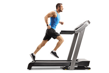 Young man in sportswear running on a professional treadmill - Powered by Adobe