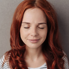 Serene young woman with closed eyes