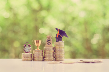 School funding, saving for higher education concept : Black graduation cap, campus diploma, US...