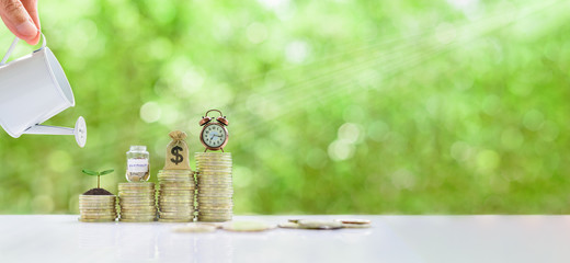 Long-tern investment, time value of money concept : Clock, US dollar bag, glass jar, a small tree on steps of rising coins. Hand pour water from a watering can, depicts asset growth from investment - obrazy, fototapety, plakaty