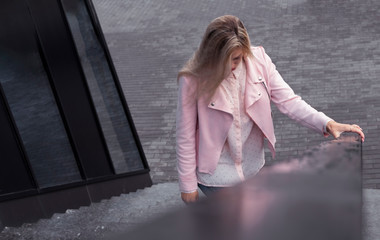 young woman in a pink suit