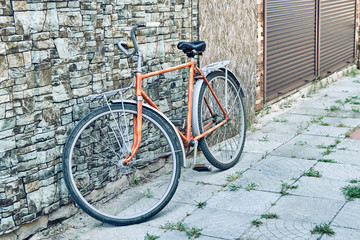 Fototapeta na wymiar Old bike on the street. Cycling, freedom of movement concept.