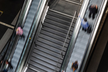 Obraz premium picture with long time exposure of an escalator with commuters