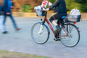 bicycle rider with shopping bags in motion blur