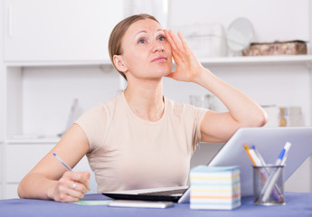 Worried woman working on laptop