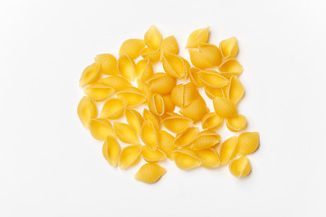 Various uncooked pasta on white background. Top view. Raw pasta with ingredients for cooking. Food concept