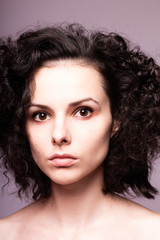 beautiful young curly girl close-up portrait