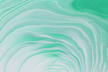 photography of abstract marbleized effect background. emerald, green, mint and white creative colors. Beautiful paint.
