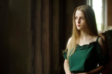 Naklejka premium serious beautiful young blonde with long flowing hair and blue eyes 