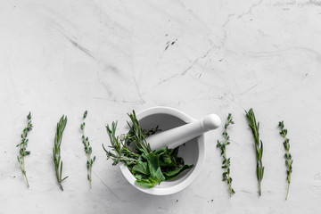 Store up medicinal herbs on white marble background top view space for text