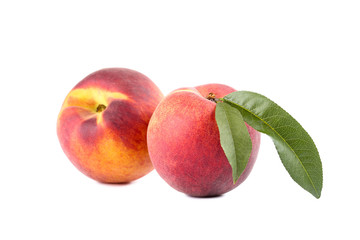 Fototapeta na wymiar Fresh peaches with green leaf isolated on white background