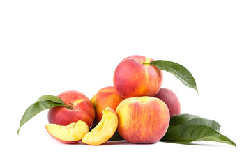 Fresh peaches with green leafs isolated on white background