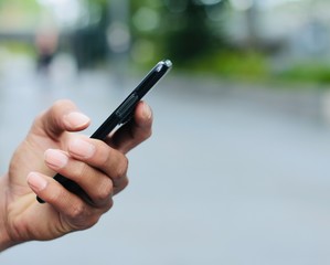 Hand holding a phone outside