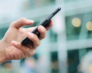 Hand holding a phone outside