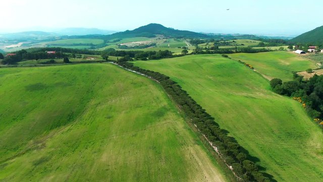 Beautiful aerial view of majestic authentic italian valley in Tuscany. Drone footage of Val dÓrcia inspiring green landscape horizon. Dream journey.