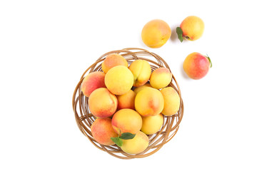 Sweet apricots in basket isolated on white background
