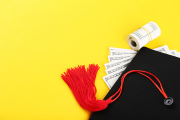 Graduation cap with dollar banknotes on yellow background