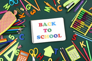 Text Back To School with stationery on green background