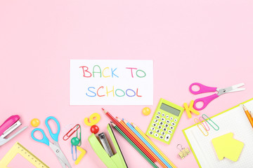 Text Back To School with stationery on pink background