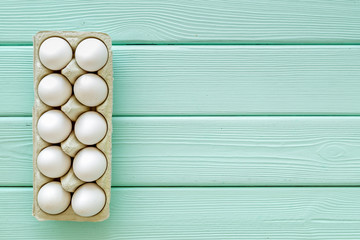 Fresh eggs for organic food on mint green wooden background top view mockup