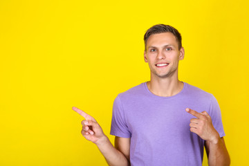 Portrait of young man on yellow background