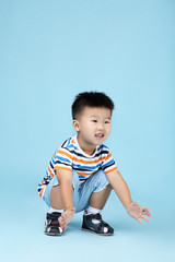 Beautiful boy in fashion clothing on blue background