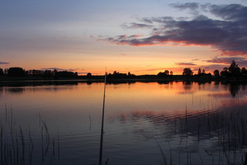 Fishing on the lake on a warm evening, in the middle of summer. A unique image of the surrounding nature.