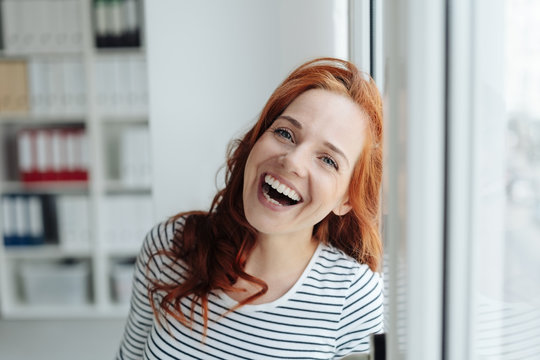 Laughing vivacious woman enjoying a joke