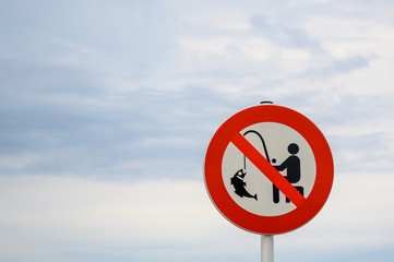 Strictly no fishing sign against a sky background