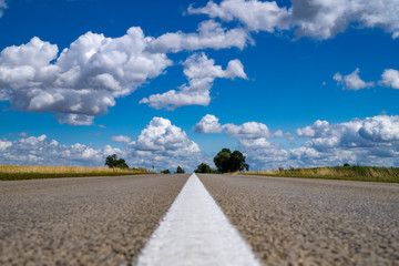 Low angle view of a tarred road receding
