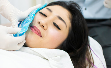 A beautiful woman got cold compress before botox injection