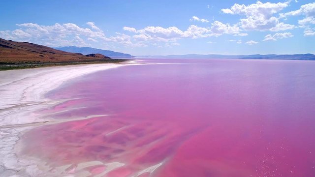 Flying backwards over the Great Salt Lake in pink phase from high salt levels and halophilic bacteria.