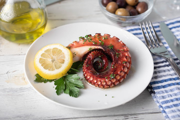 greek grilled octopus on white plate © ahirao
