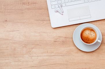 Coffee, laptop and headphones on wooden table. Relax concept