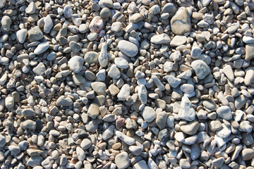 Pebbles and little stones, beach background texture