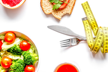 concept slimming diet fresh vegetables on white background top view