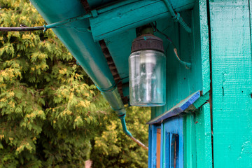 old lantern under the roof of the house