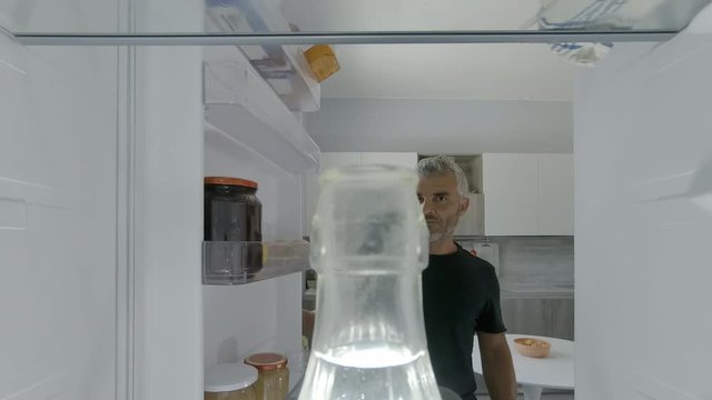 Man Takes Water Bottle From Fridge And Drink It Point Of View Pov