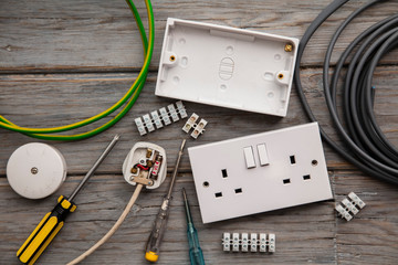 Electrical tools and equipment on a wooden background