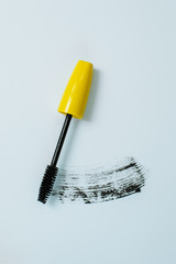yellow mascara on a white background