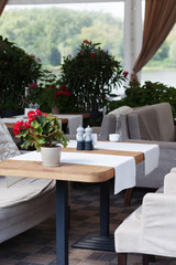 Table and chairs in park cafe. Modern design interior. Concept of vacation and leisure