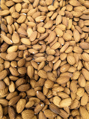 Closeup of shelled roasted almonds as background. Concept of healthy and nutritious food