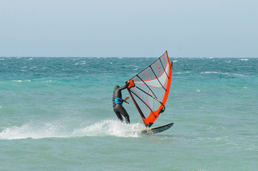 Funny windsurfing on the crystal clear water