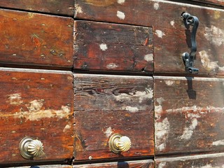 The knocker and handles on the old wooden house door