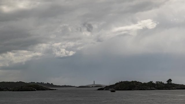 Timelapse of rain clouds rolling over the Norway countryside. Zoom in.