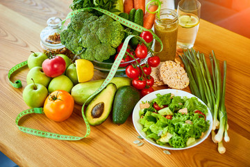 Diet weight loss breakfast concept with tape measure, organic fruits , vegetables, salad and fresh water. Healthy nutrition concept, Lifestyle and Eating