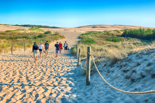 LEBA, POLAND - JULY 25, 2019: Slowinski National Park is situated on the Baltic Sea coast, near Leba, Poland. Desert landscape with the largest moving sand dunes in Europe. Hot day with clear sky.