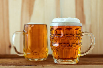 Two full jugs of beer on bar counter