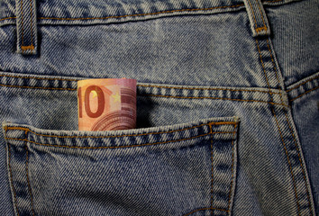 A few euro stick out of my pocket. Paper money is in a ji-pocket. Cash bills are stored in a jeans pocket. Pocket money for small expenses